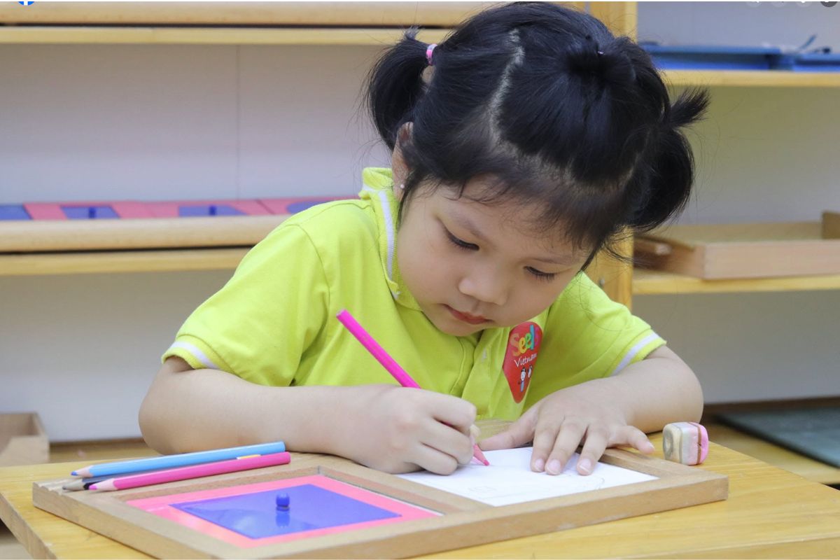 Young child developing fine-motor control through a Montessori-informed pre-writing activity
