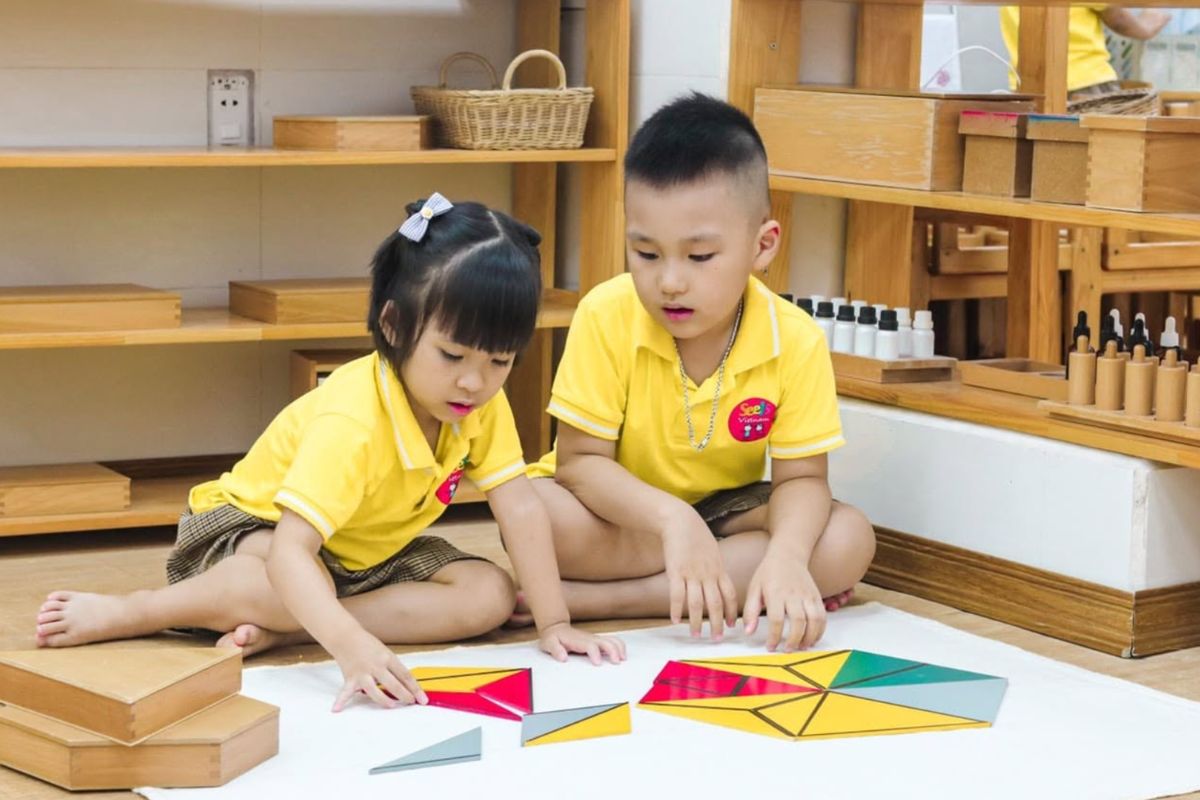 Parent or teacher sharing objects, pictures or a story with a young Filipino child