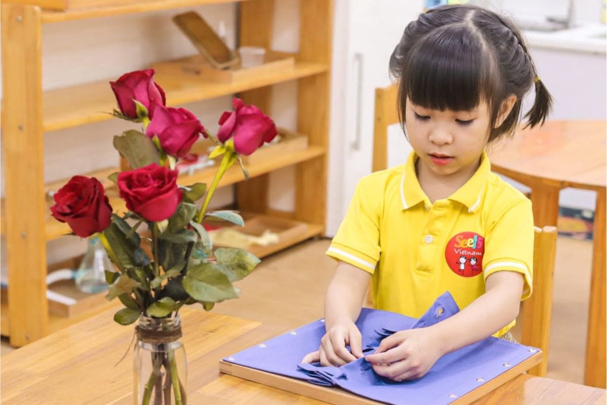 Young child working independently with a Montessori-informed Practical Life activity
